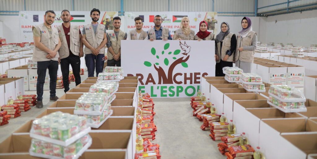 Équipe de bénévoles devant des colis alimentaires prêts à partir
